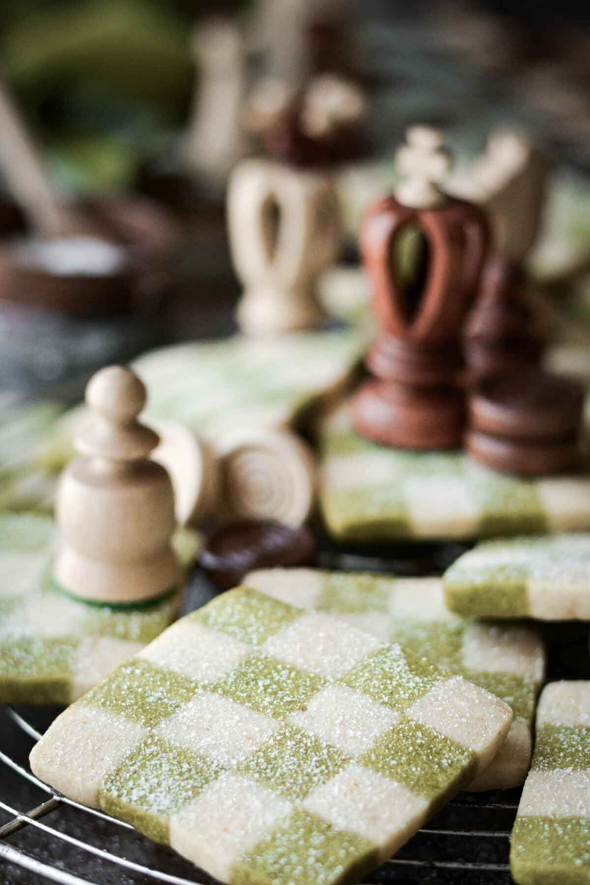 Green and white checkerboard cookies, arranged with chess pieces.