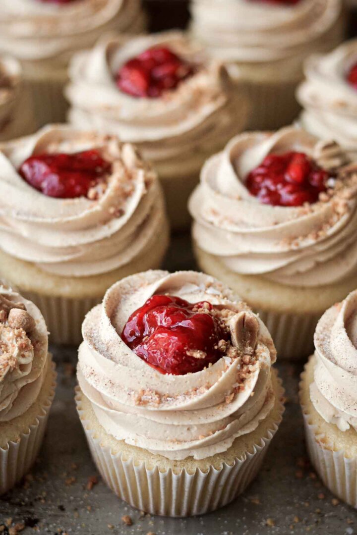 Peanut butter and jelly cupcakes, topped with strawberry compote and crushed peanuts.