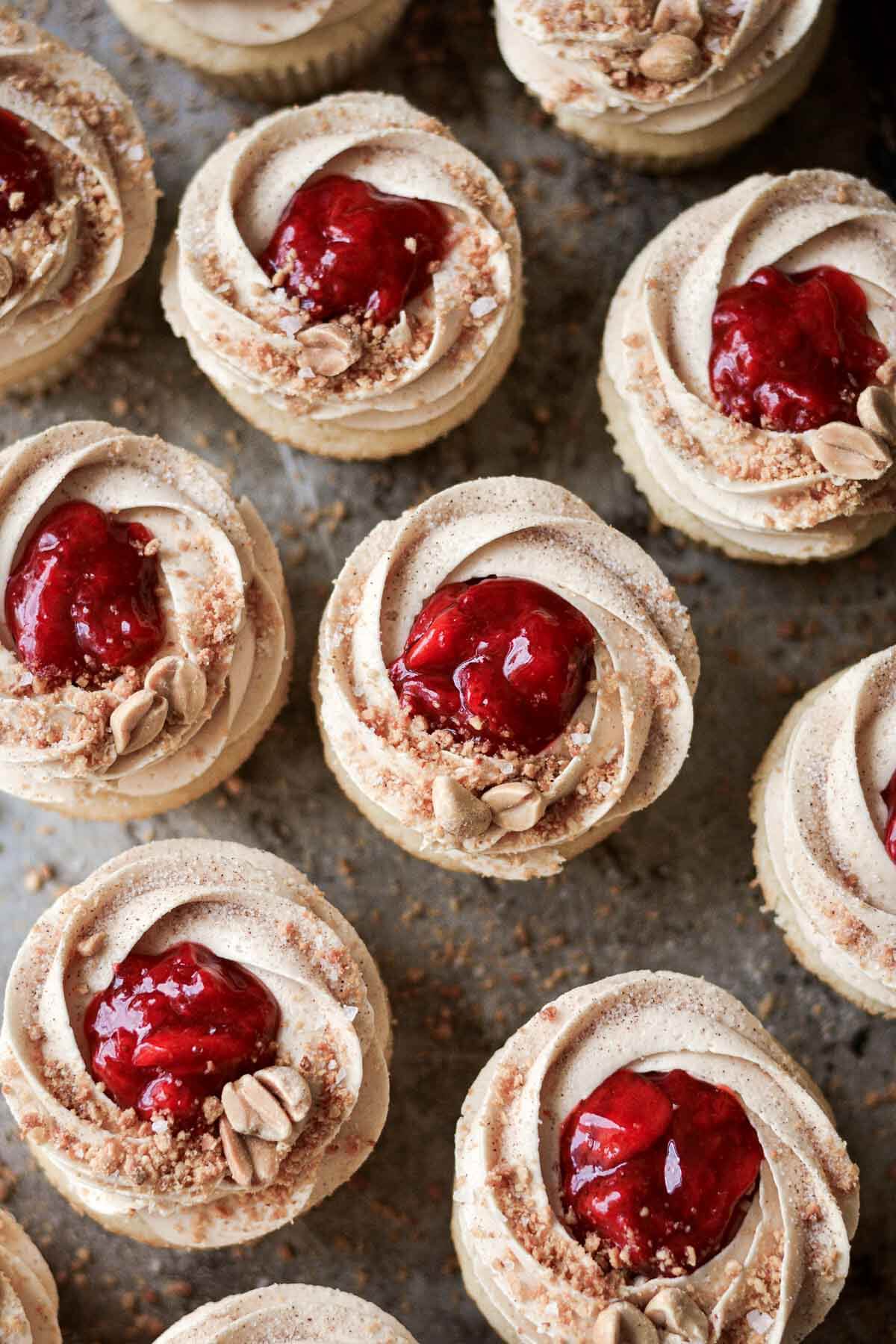 Peanut butter and jelly cupcakes, topped with strawberry compote and crushed peanuts.