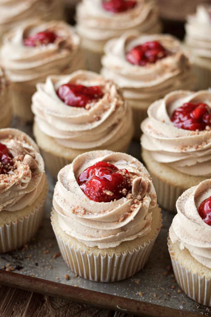 Peanut butter and jelly cupcakes, topped with strawberry compote and crushed peanuts.