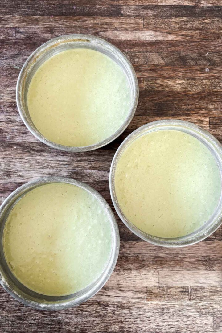 Step 5 for making matcha cake - cake batter in pans.