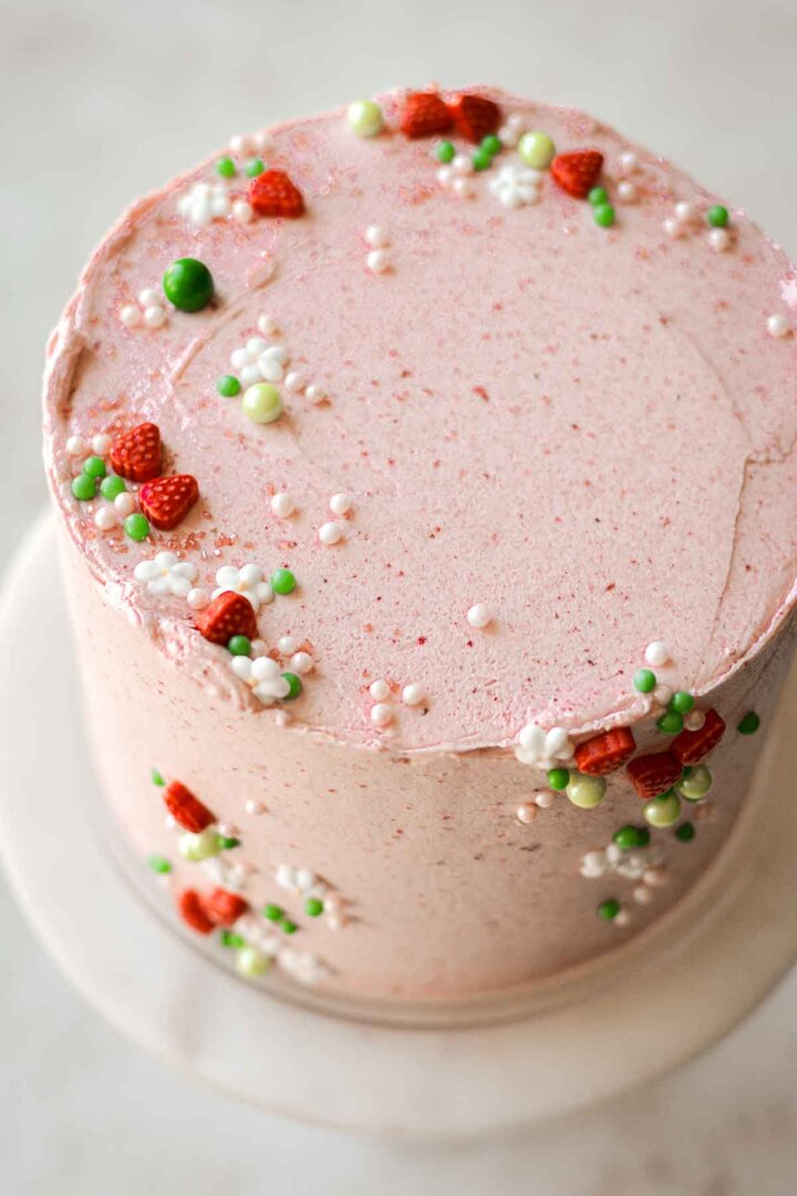 Strawberry matcha cake decorated with a strawberry summer sprinkle mix.
