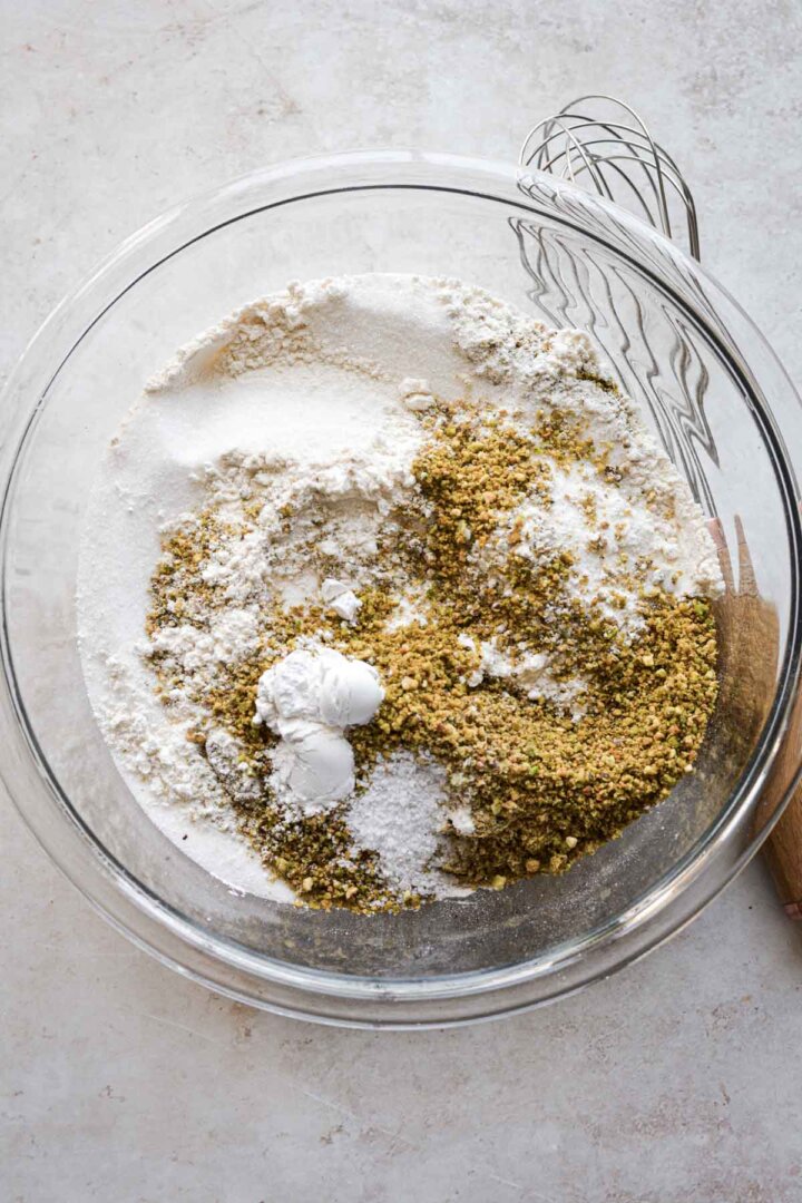 Step 1 for making strawberry pistachio cupcakes - mixing dry ingredients with chopped pistachios.