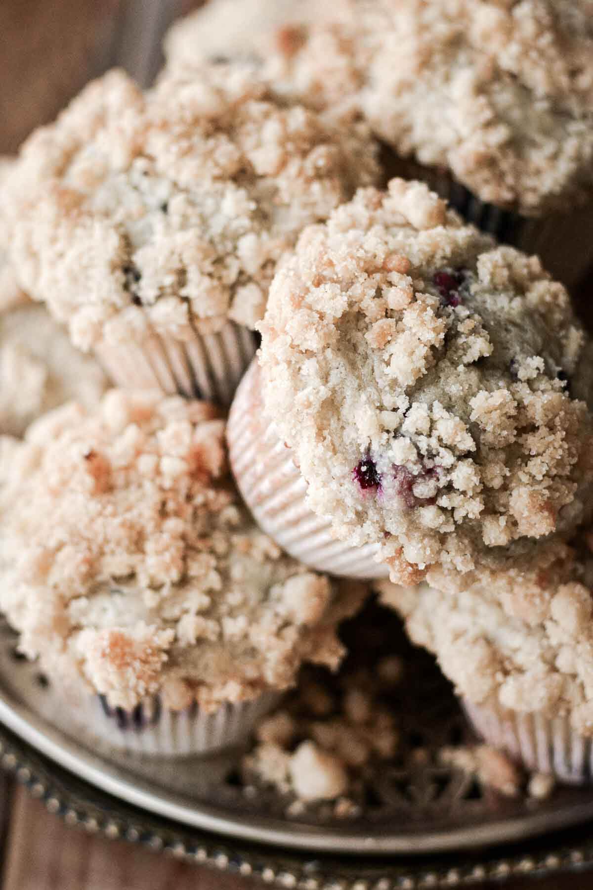 Blueberry crumb muffins on a plate.