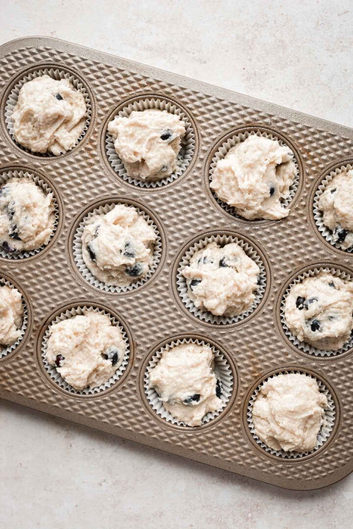 Blueberry muffin batter in a pan.