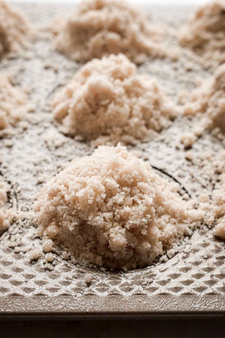 Crumb topping on blueberry muffin batter.
