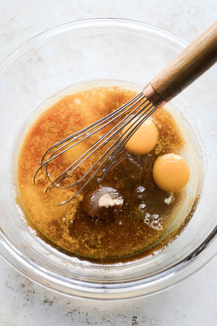 Step 1 for making butter pecan blondies - whisking butter, sugar and eggs.