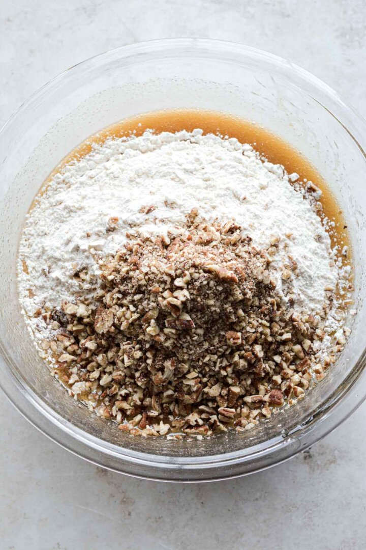 Step 3 for making butter pecan blondies - adding flour and pecans.
