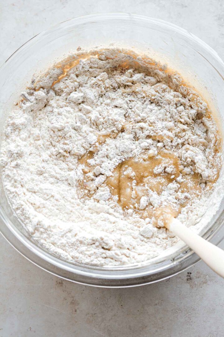 Step 4 for making butter pecan blondies - adding flour and pecans.