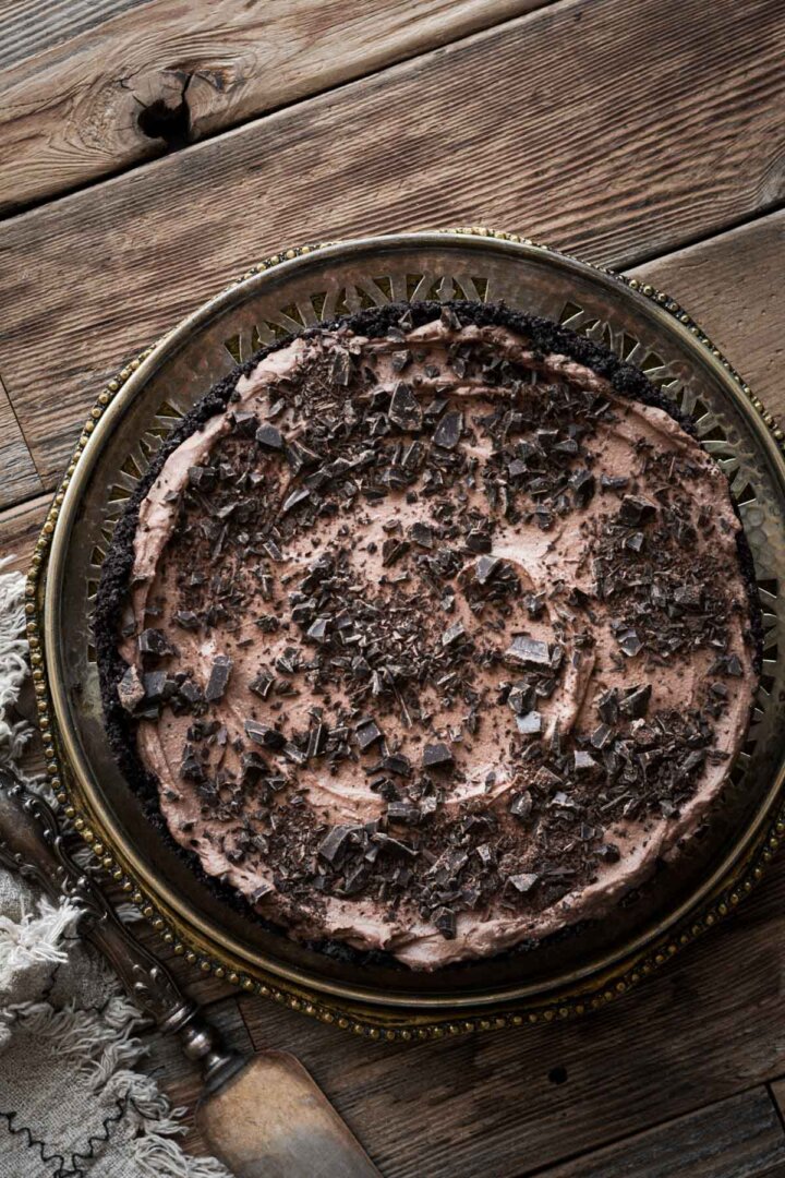 No bake chocolate cheesecake topped with chopped chocolate.