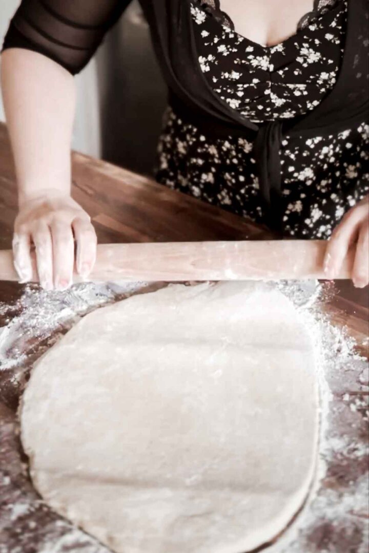 Step 1 for making a giant cinnamon roll cake - rolling out dough.