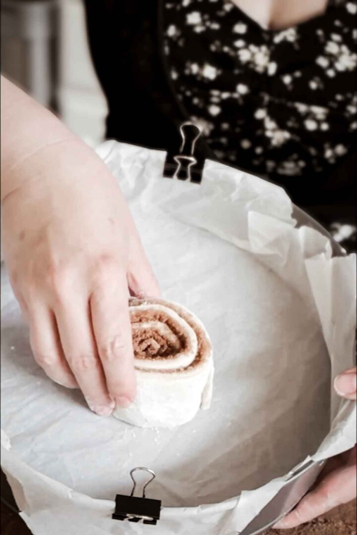 Step 4 for making a giant cinnamon roll cake - arranging the dough in a pan.