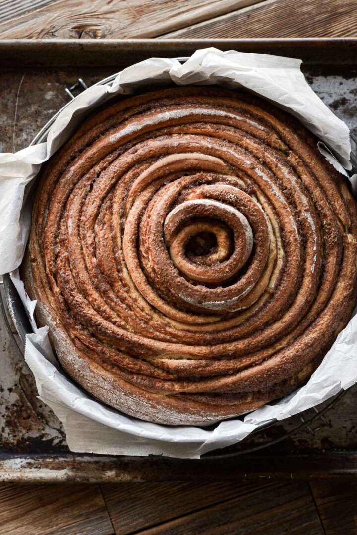 Step 8 for making a giant cinnamon roll cake - the baked cake in a pan.
