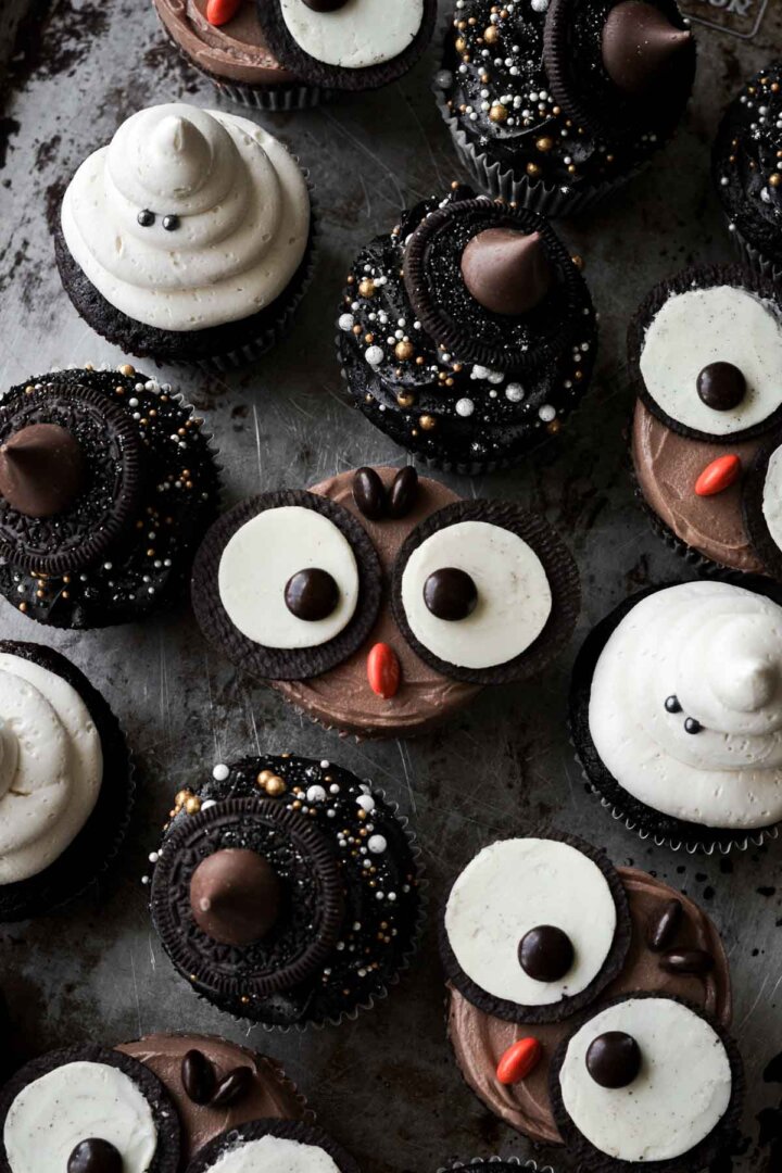 Halloween cupcakes, including owls, ghosts, and witch hats.