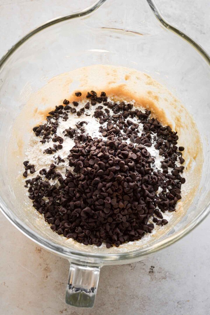 Step 3 for making chocolate chip cookies - adding flour and chocolate chips.