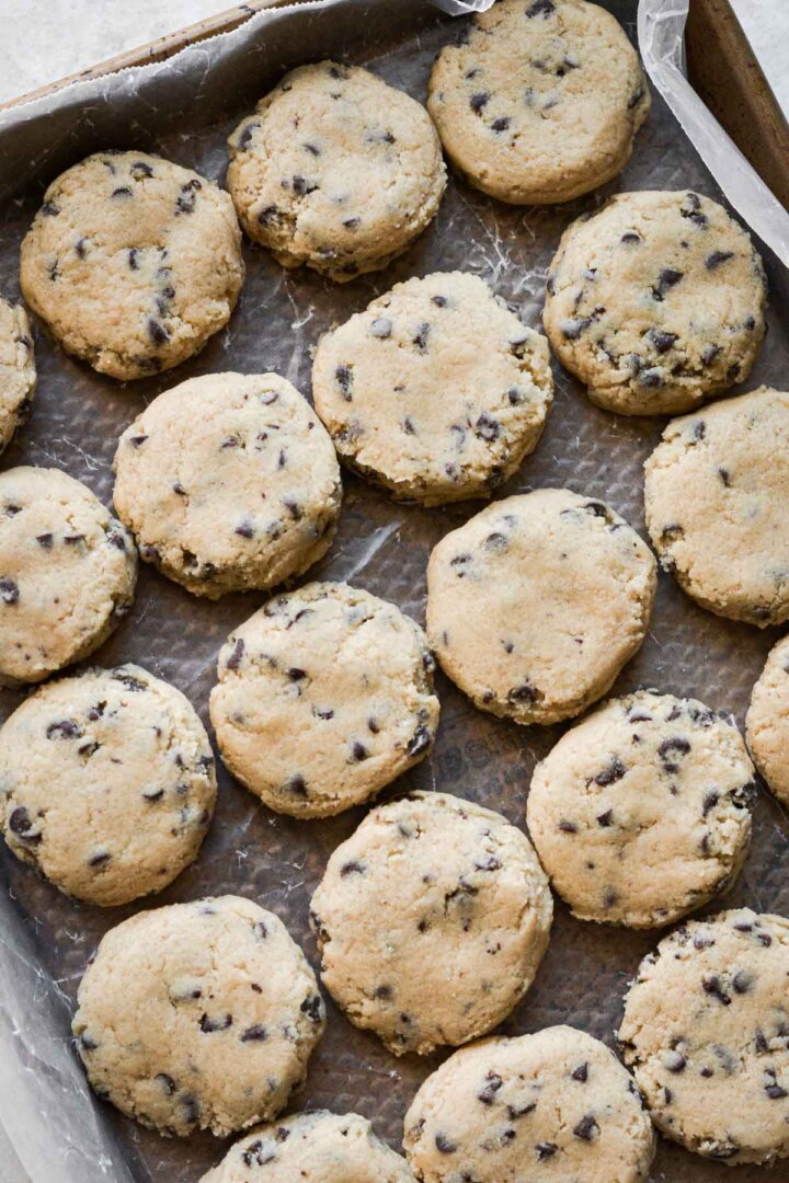 Chocolate chip cookie dough balls, pressed flat.