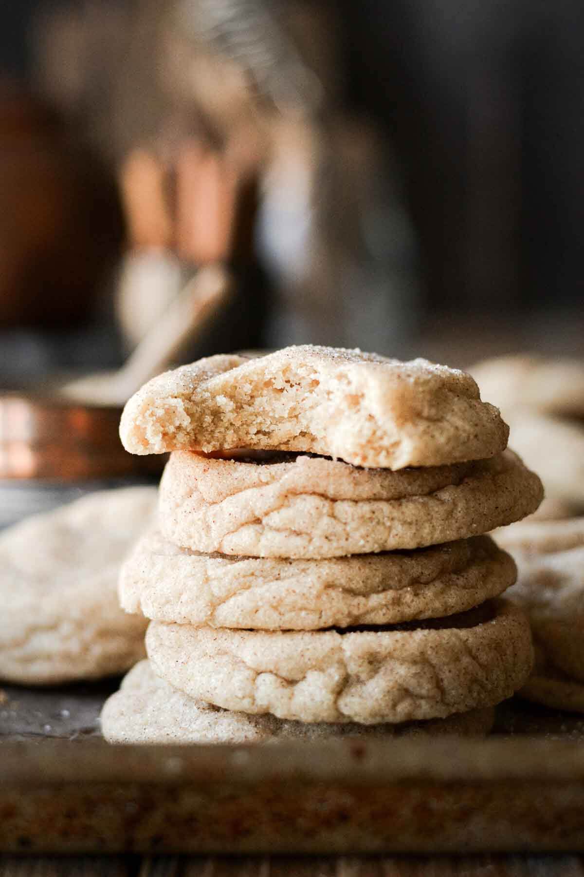Stack of snickerdoodles, one with a bite taken.