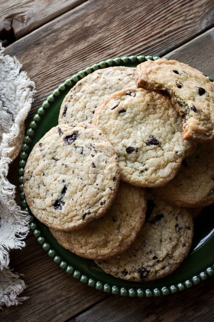 Chocolate chip cookies on a green plate.