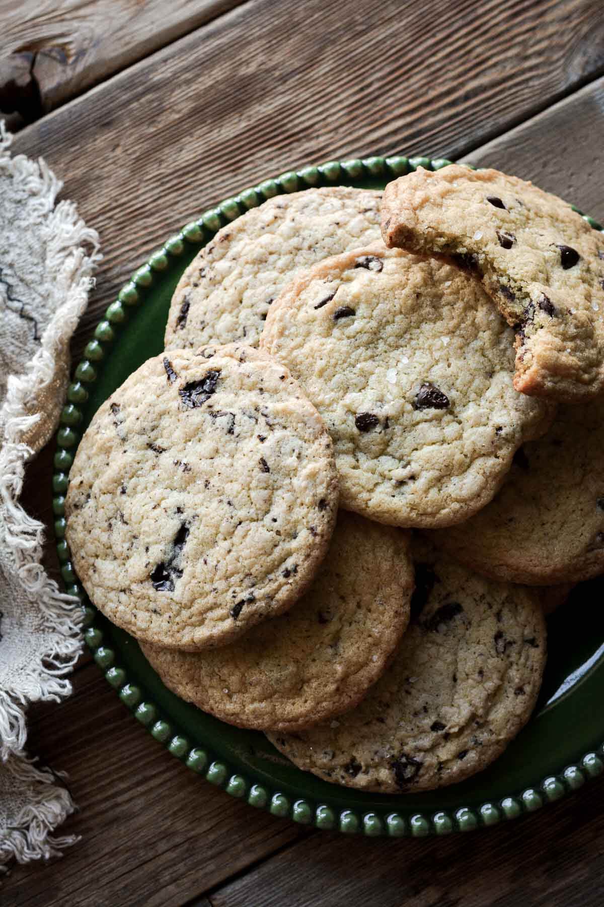 Chocolate chip cookies on a green plate.
