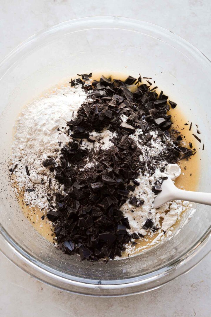 Step 2 for making chocolate chip cookies - adding flour and chocolate.