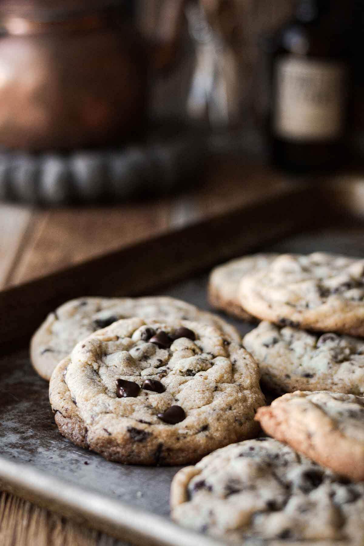 Big bakery style chocolate chip cookies on a baking sheet.