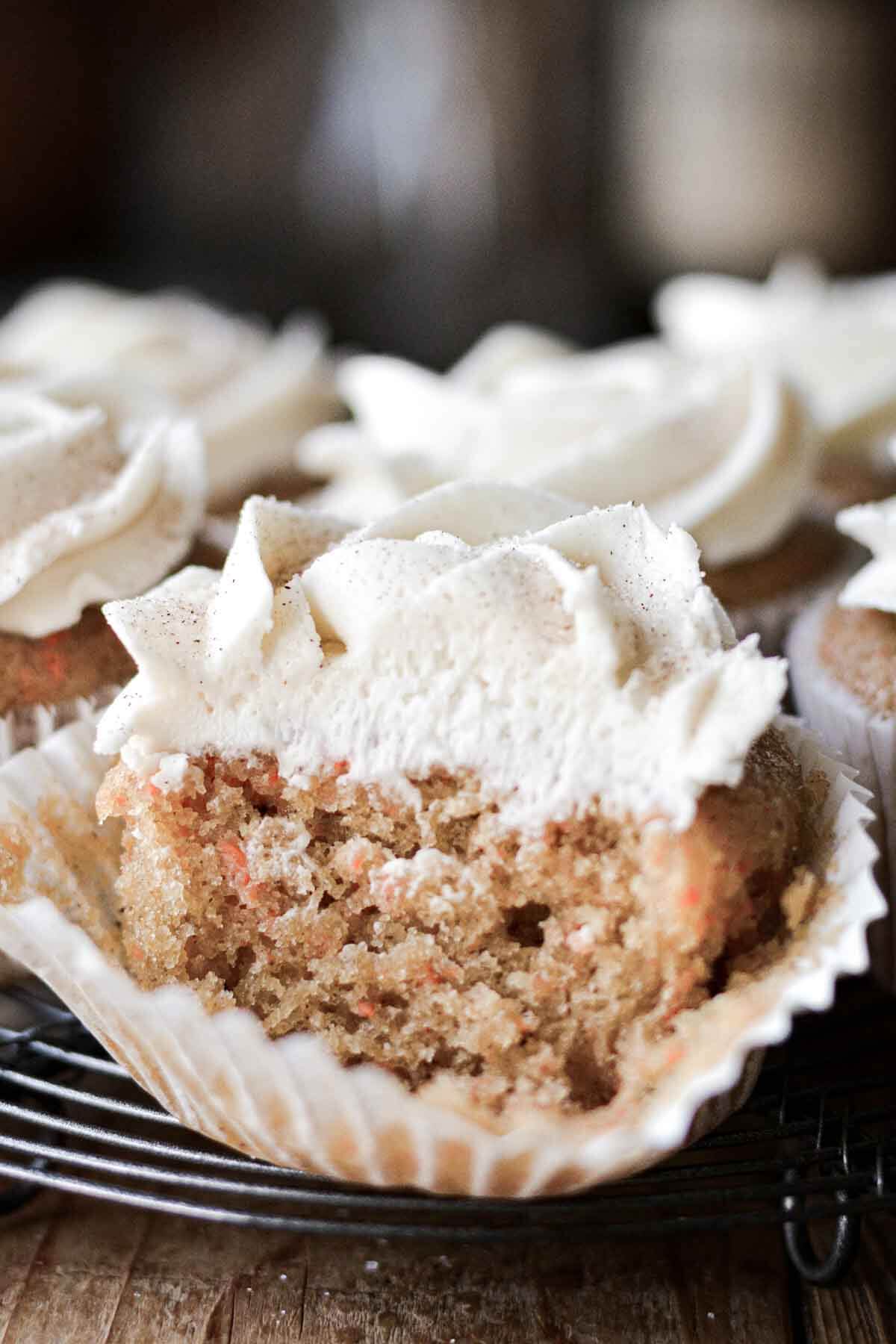 Carrot cupcake with a bite taken.