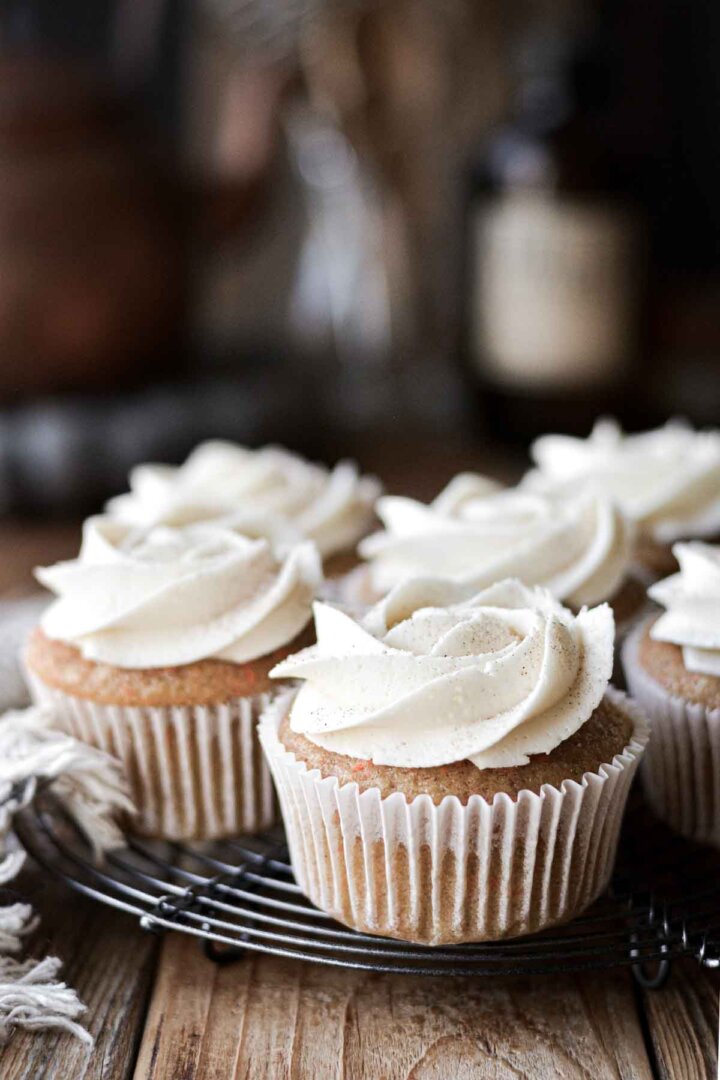 Carrot cake cupcakes on a cooling rack.