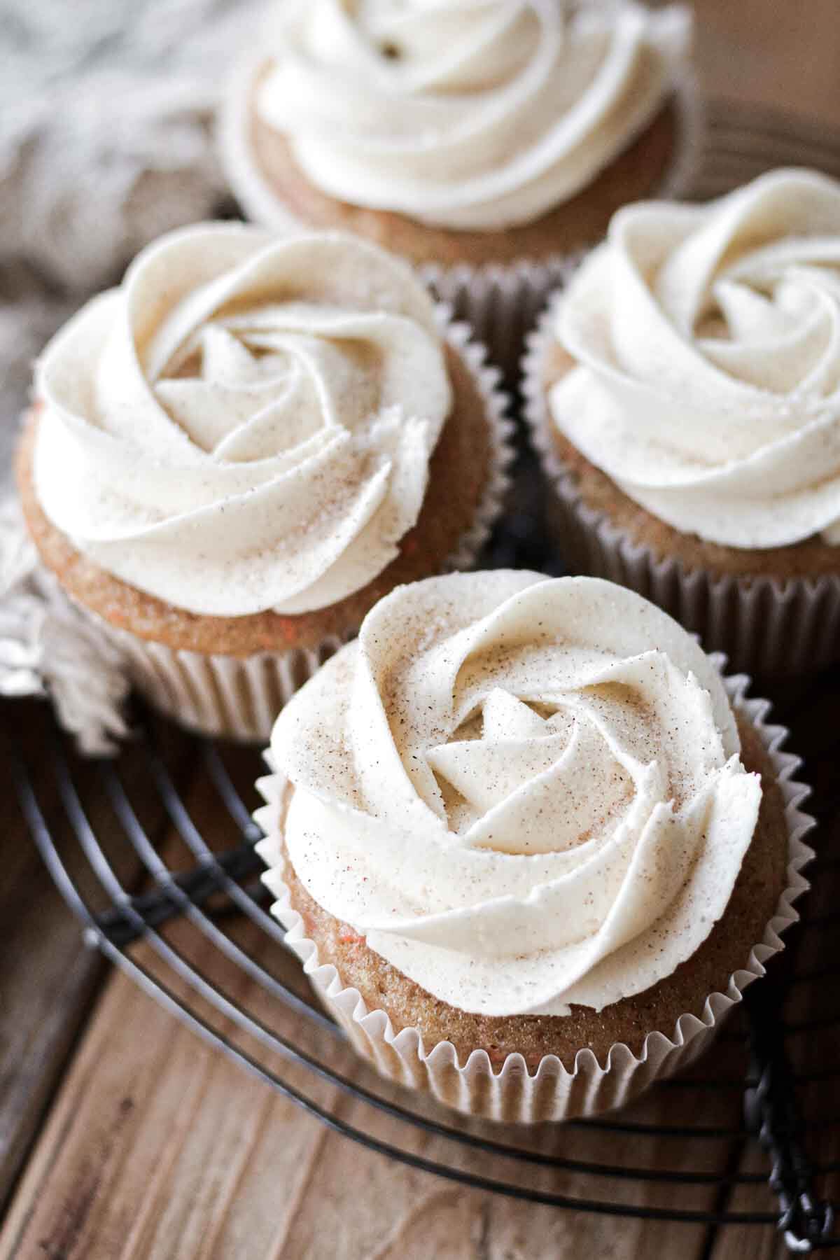 Carrot cake cupcakes with piped swirls of cream cheese buttercream.