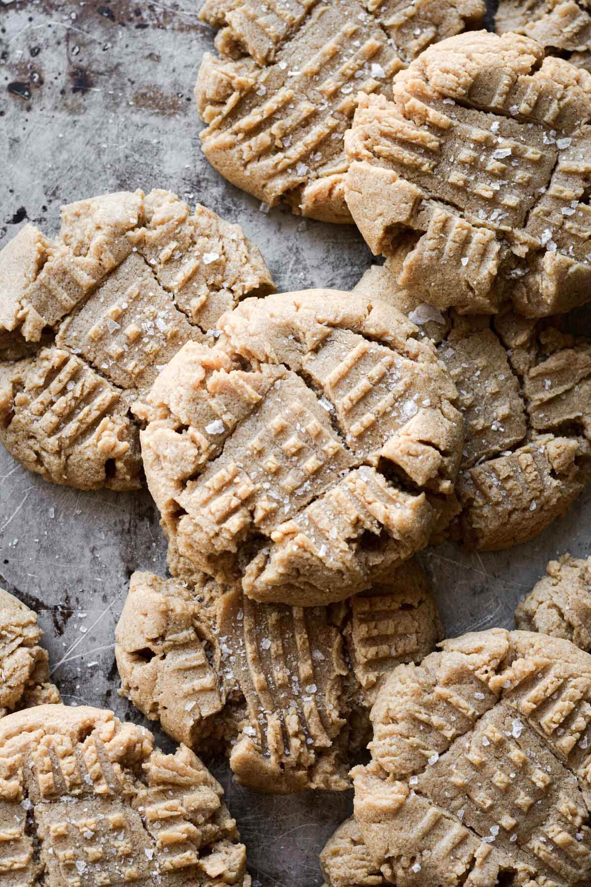 Peanut butter cookies with crispy edges, sprinkled with salt.