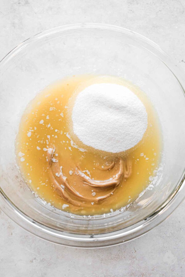 Step 1 for making peanut butter cookies - whisking peanut butter, sugar and butter.