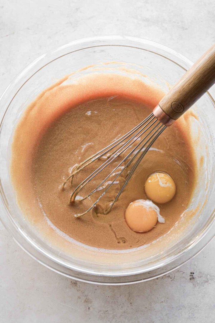 Step 2 for making peanut butter cookies - whisking in eggs.