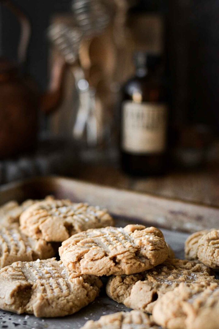 Crunchy peanut butter cookies on a baking sheet.