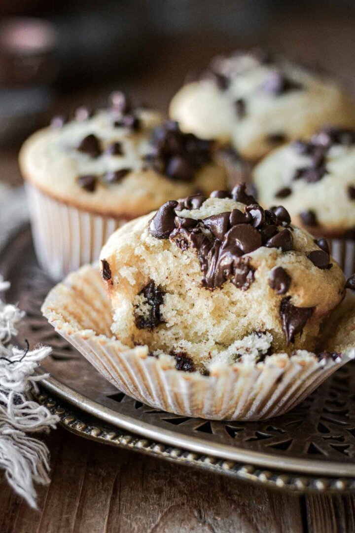 Chocolate chip muffin with a bite taken.
