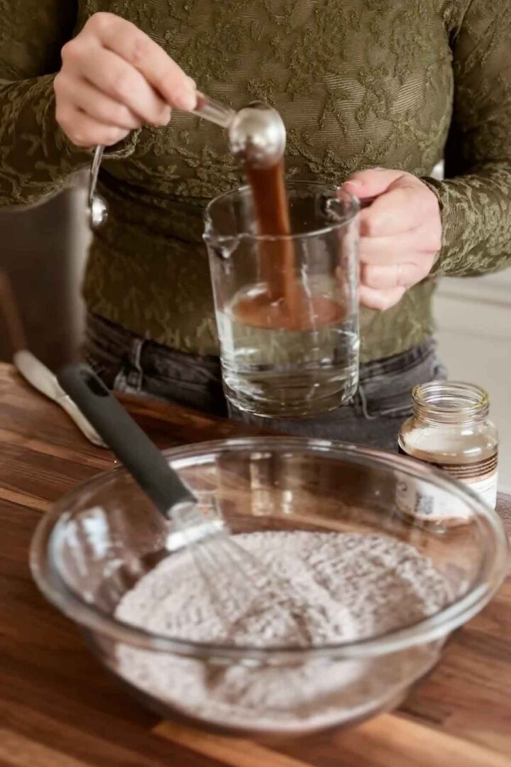 Adding espresso powder to water.