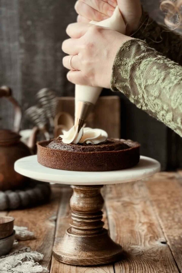 Frosting a cake with a piping bag.