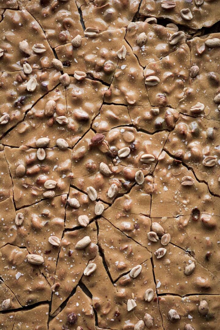 Step 7 for making peanut brittle - breaking the candy into chunks.