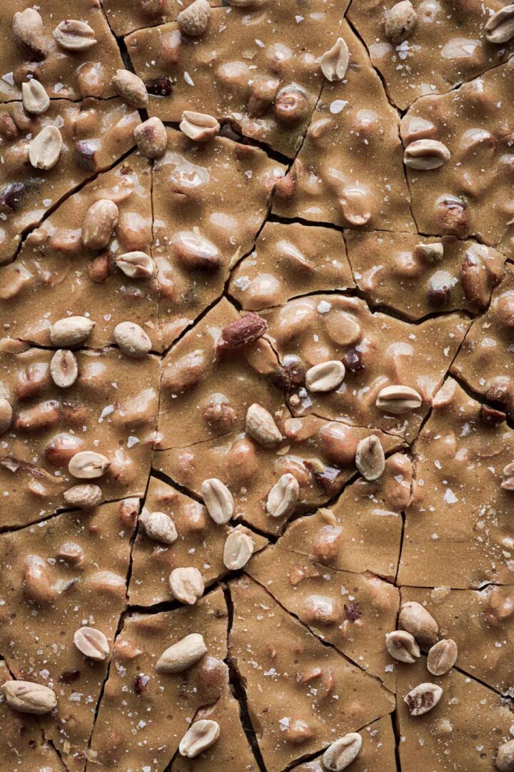 Peanut brittle, broken into jagged chunks.