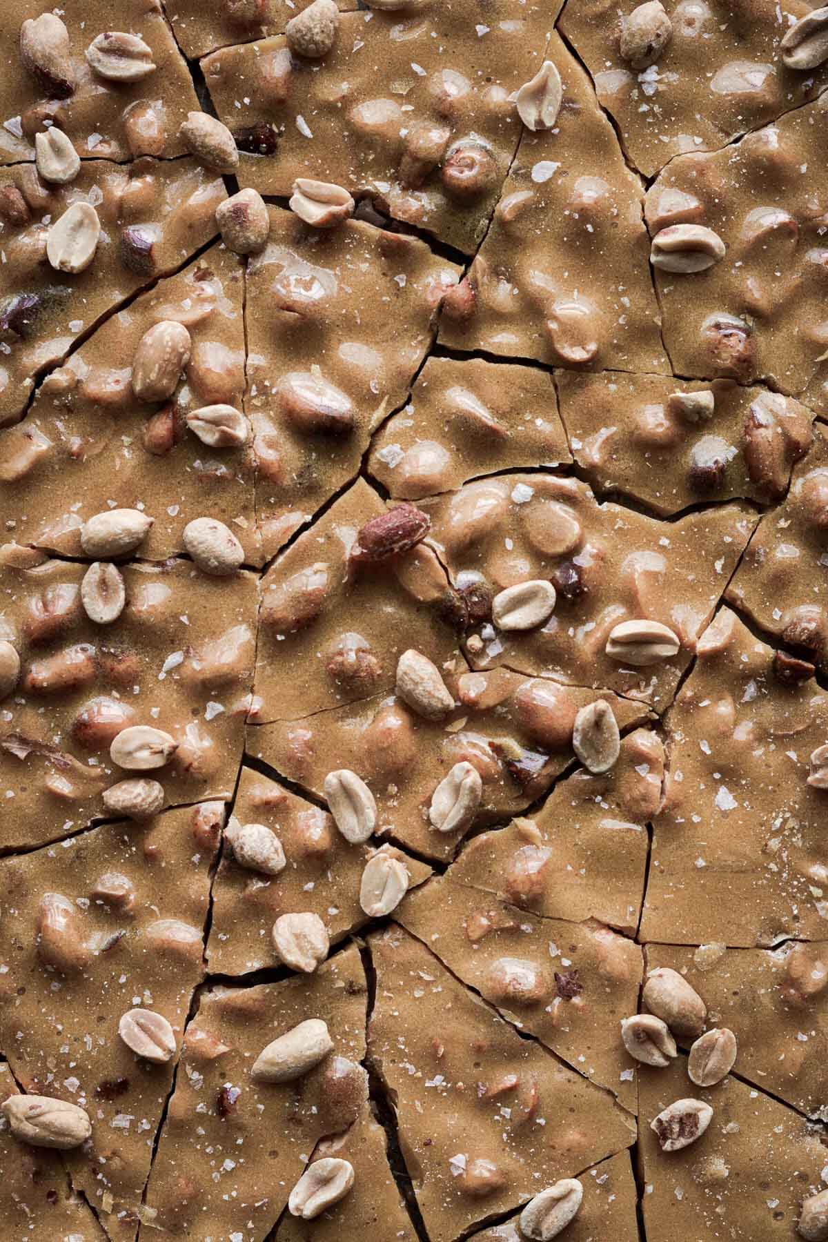 Peanut brittle, broken into jagged chunks.