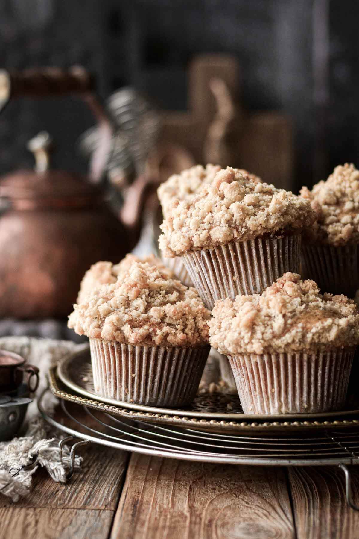 Pumpkin crumb muffins stacked on a tray.