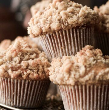 Pumpkin crumb muffins stacked on a tray.