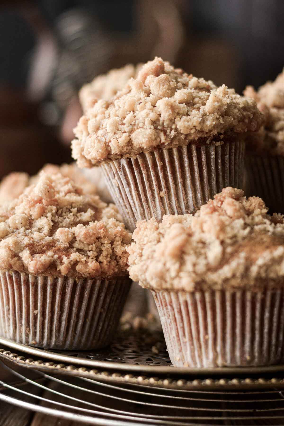 Pumpkin crumb muffins stacked on a tray.
