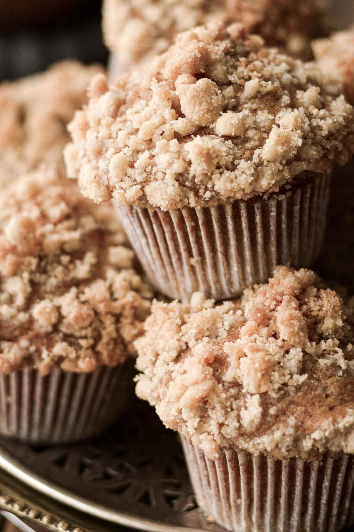 Pumpkin crumb muffins stacked on a tray.