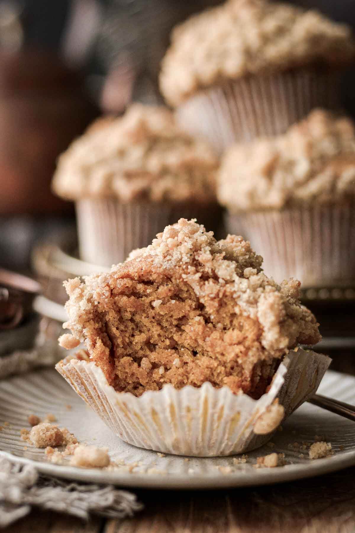 Pumpkin crumble muffin with a bite taken.