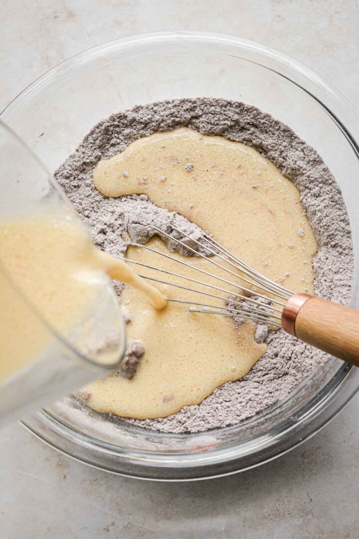 Step 2 for making red velvet chocolate chip cake - adding liquid ingredients.