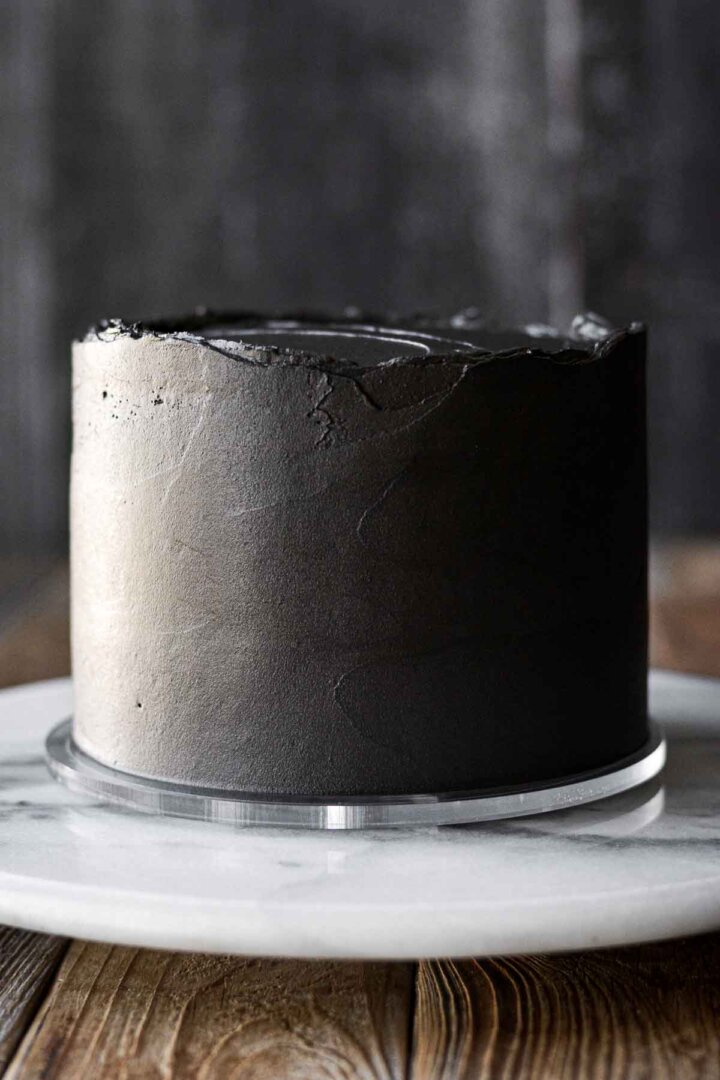 A smooth coat of black cocoa buttercream on a layer cake.