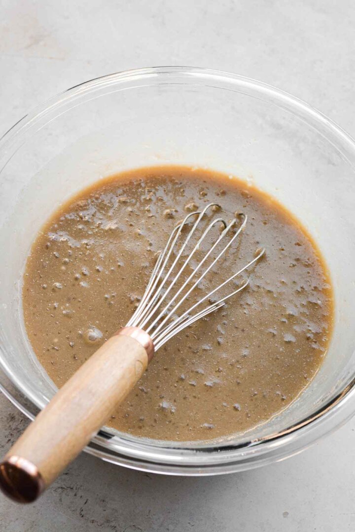 Step 2 for making cashew cake - whisking liquid ingredients.