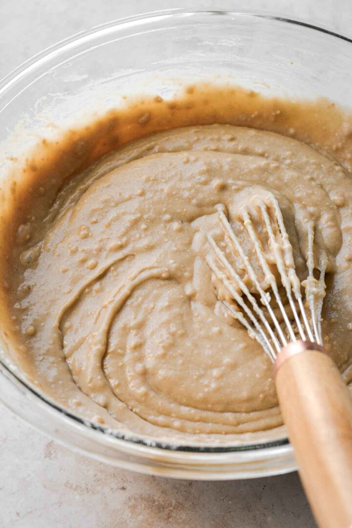 Step 5 for making cashew cake - whisking the batter.