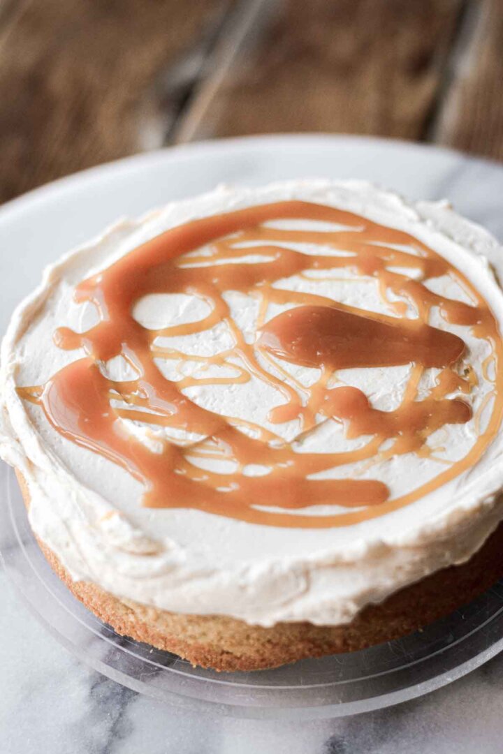 Step 8 for making cashew cake - layering the cakes with buttercream and caramel.