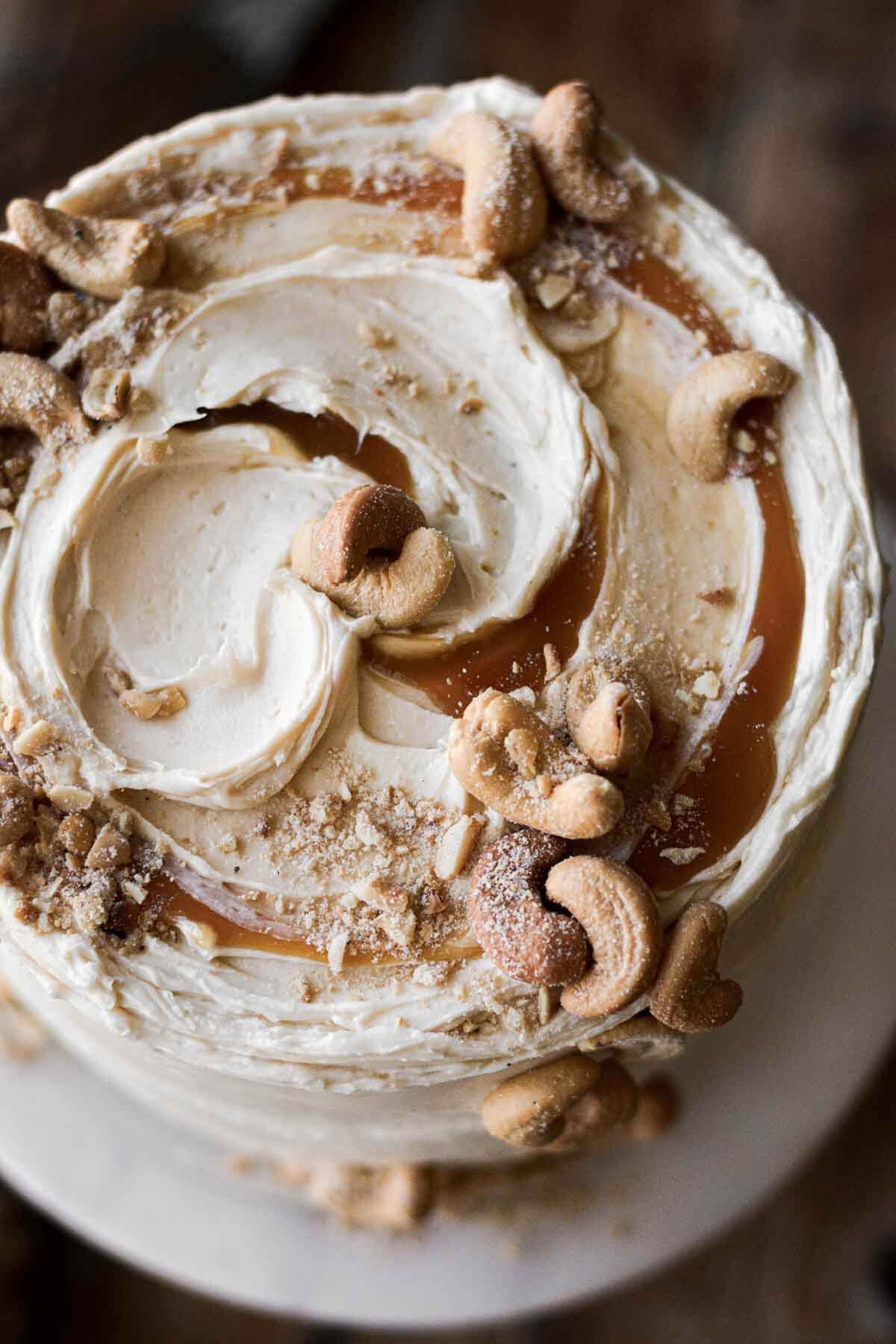 Salted caramel and cashews on top of a cake.