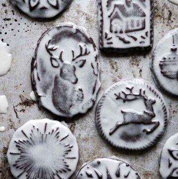 Iced chocolate Christmas cookies stamped with Christmas designs.